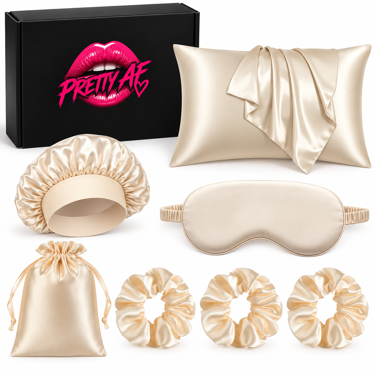 A satin sleep and beauty gift set on a white background, including a black box with pink lips branding, a satin pillowcase with a draped scarf, a satin bonnet, a satin sleep mask, a satin drawstring pouch, and three satin scrunchies.